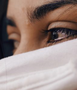 woman's eyes are filled with tears because of chronic illness