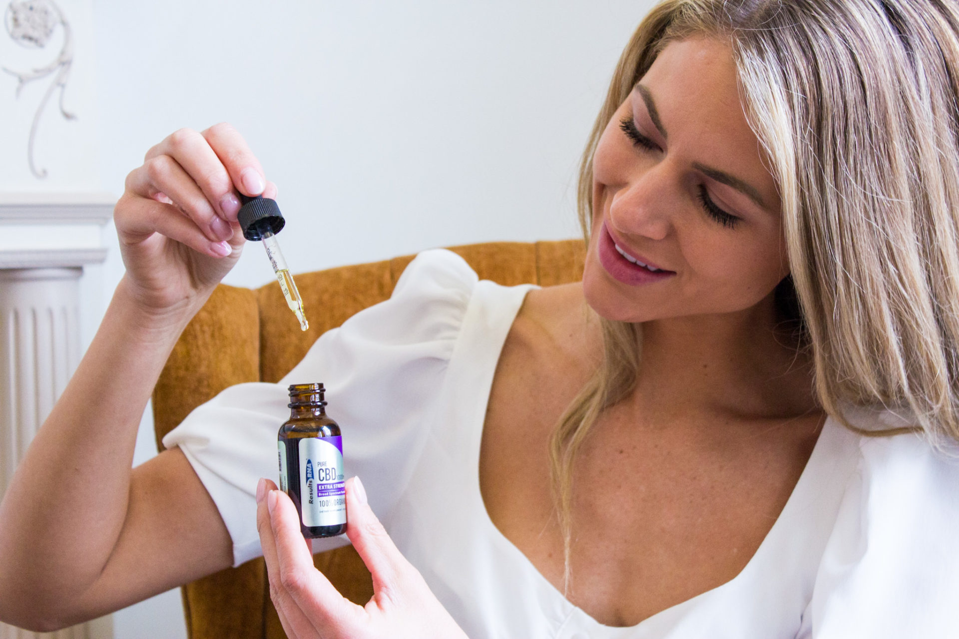 Woman holds Results RNA Pure CBD to help with Lyme disease symptoms.